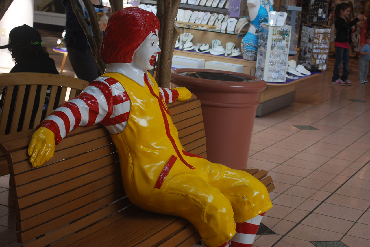 Clown figure sitting on bench